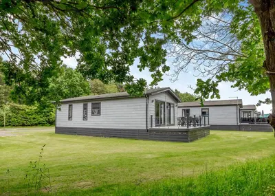 a home with a large yard in front of it at The Essex Golf And Country Club in Markshall