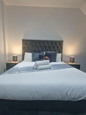 a bedroom with a large bed with two night stands at WNS Southend-on-Sea in Southend-on-Sea