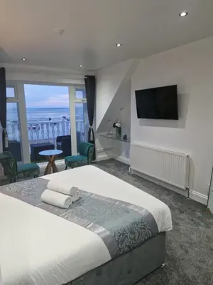 a bedroom with a bed and a flat screen tv at WNS Southend-on-Sea in Southend-on-Sea