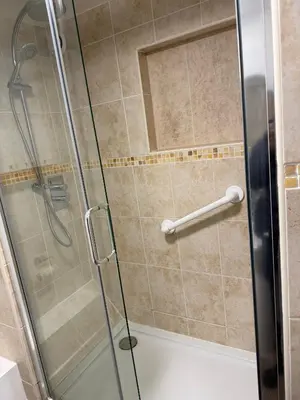 a shower with a glass door in a bathroom at Kings Lodge in Newmarket