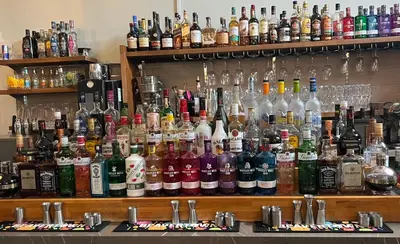 a bar with a large amount of bottles of alcohol at Kings Lodge in Newmarket