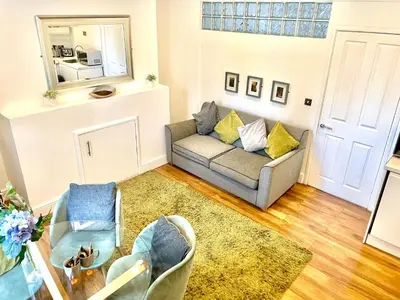 a living room with a couch and two chairs at EMMANUEL HOUSE - Beautiful 1-Bedroom Apt In Central Cambridge - Historical Building in Cambridge