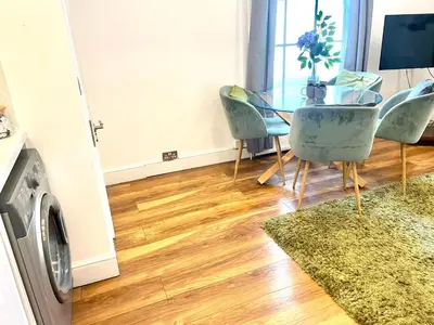 a dining room with a glass table and chairs at EMMANUEL HOUSE - Beautiful 1-Bedroom Apt In Central Cambridge - Historical Building in Cambridge