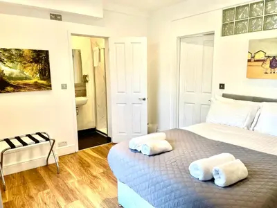 a bedroom with a bed with two towels on it at EMMANUEL HOUSE - Beautiful 1-Bedroom Apt In Central Cambridge - Historical Building in Cambridge