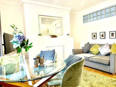 a living room with a glass table and a couch at EMMANUEL HOUSE - Beautiful 1-Bedroom Apt In Central Cambridge - Historical Building in Cambridge