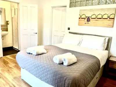 a bedroom with a bed with two towels on it at EMMANUEL HOUSE - Beautiful 1-Bedroom Apt In Central Cambridge - Historical Building in Cambridge