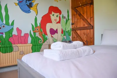 a room with a bed with towels on it at Moat Barn in Debach