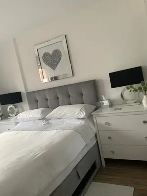 a bedroom with a bed and a desk with two monitors at Blanco Uno in Colchester