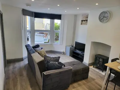 a living room with a couch and a fireplace at Colchester House with garden and parking- Sleeps up to 7 - Free Wi-Fi - Contractors - Families - Long Term Stays in Colchester