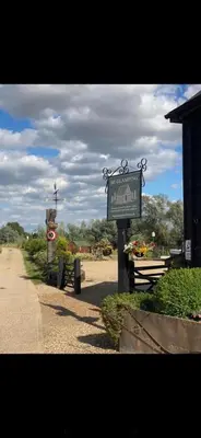 a sign for the entrance to a garden with flowers at Lake View Lodges The Kentwell in Long Melford