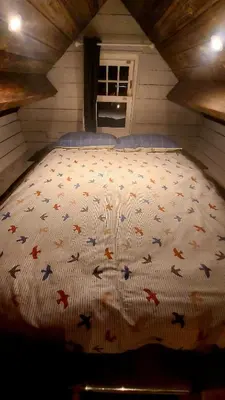 a bedroom with a bed with a comforter on it at Lake View Lodges The Kentwell in Long Melford