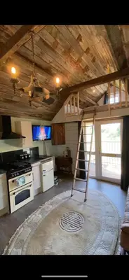 a kitchen with a ladder in the middle of a room at Lake View Lodges The Kentwell in Long Melford