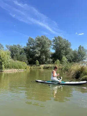 a man sitting on a kayak in the water at Lake View Lodges The Kentwell in Long Melford