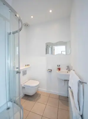 a bathroom with a toilet and a sink and a shower at The Royal Burnham Yacht Club in Burnham on Crouch