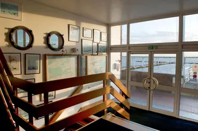 a staircase in a building with mirrors on the wall at The Royal Burnham Yacht Club in Burnham on Crouch