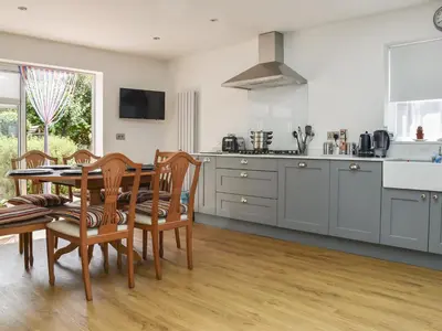 a kitchen with a table and chairs in a kitchen at Sunnyside in Colchester