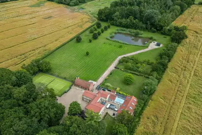 an aerial view of a house in a field at Cottage In Norfolk Sleeps 23 - Private Pool, Fishing Lake, Hot Tub Ref 99008Sc in Hockham