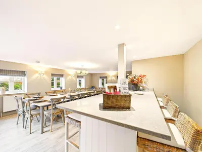 a kitchen and dining room with tables and chairs at Cottage In Norfolk Sleeps 23 - Private Pool, Fishing Lake, Hot Tub Ref 99008Sc in Hockham