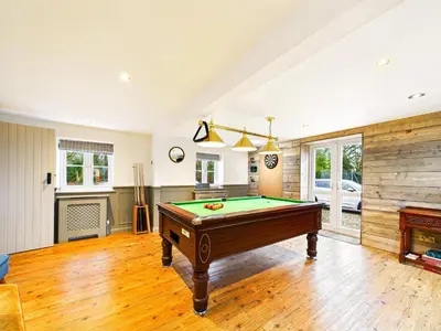 a living room with a pool table and a fireplace at Cottage In Norfolk Sleeps 23 - Private Pool, Fishing Lake, Hot Tub Ref 99008Sc in Hockham