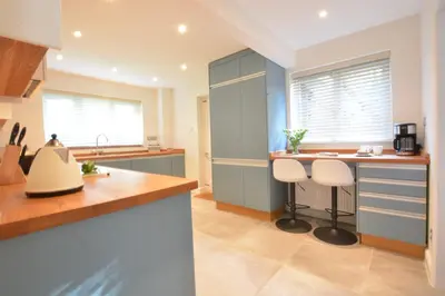 a kitchen with two stools at a kitchen counter at Town Farm House, Orford in Orford