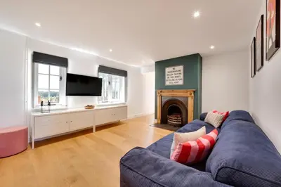 a living room with a blue couch and a fireplace at 4 Bed in Spexhall oc-fairs in Spexhall