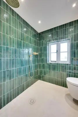 a green tiled bathroom with a shower and a toilet at 4 Bed in Spexhall oc-fairs in Spexhall