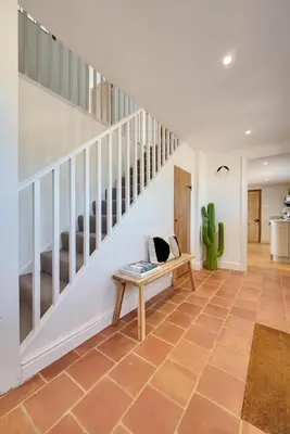 a living room with a staircase and a bench at 4 Bed in Spexhall oc-fairs in Spexhall
