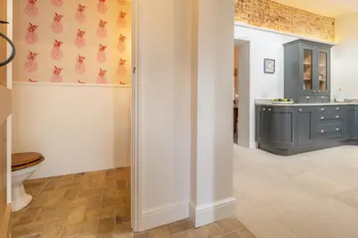 a bathroom with a toilet and a sink at Luxurious rural retreat - Holt Coach House in Sudbury