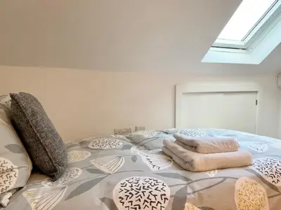 a bedroom with a large bed with pillows on it at 72 Ashley Road in Newmarket