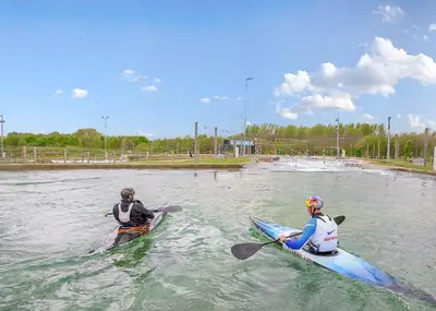 two people in kayaks in the water on a river at Lee Valley in Hoddesdon