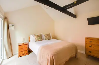 a bedroom with a bed and a wooden dresser at 3 Bed in Yoxford oc-bmy in Yoxford