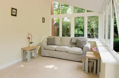 a living room with a couch and some windows at 3 Bed in Yoxford oc-bmy in Yoxford