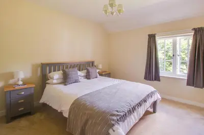 a bedroom with a large bed and a window at 3 Bed in Yoxford oc-bmy in Yoxford