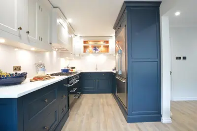 a kitchen with blue cabinets and a blue island at The Red Brick House, Aldeburgh in Aldeburgh