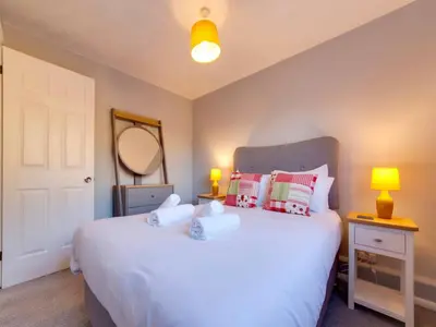 a bedroom with a white bed with pillows and a mirror at Pass the Keys Renovated Sunny Home Pass the Keys in Cambridge
