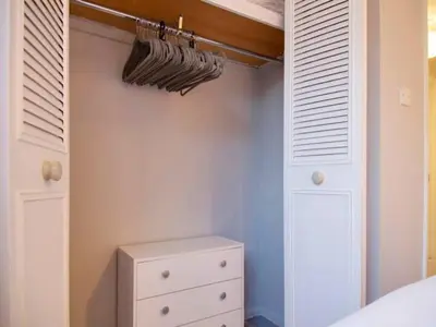 a bedroom with white cabinets and a white dresser at Pass the Keys Renovated Sunny Home Pass the Keys in Cambridge