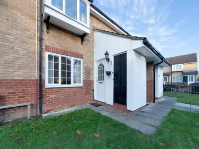 a brick house with a black and white door at Pass the Keys Renovated Sunny Home Pass the Keys in Cambridge