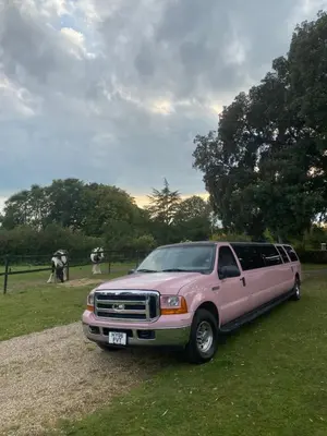 a pink truck parked on the grass in a field at Grade II Listed Farmhouse, Pool, Hot Tub, Games Room, Celebration Hall, Car Park, 10ppl, 45 min from Central London in Stapleford Tawney