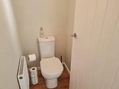 a bathroom with a white toilet in a room at The Farmhouse - Linton Horseheath in Linton