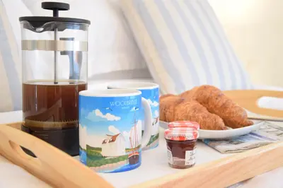 a tray with a coffee maker and pastries on a table at 1 Tailors Cottage, Woodbridge in Woodbridge