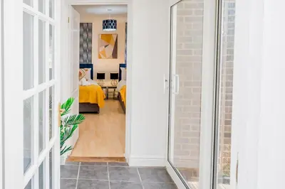 a hallway with a door leading to a bedroom at Modern and Spacious 4 Bedroom Home in Ipswich in Ipswich