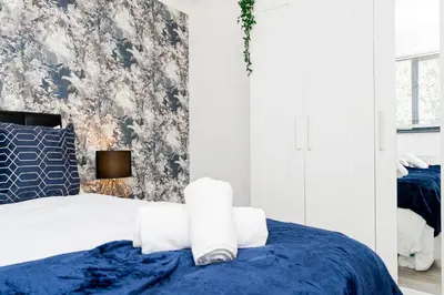 a bedroom with a bed with towels on it at Modern and Spacious 4 Bedroom Home in Ipswich in Ipswich