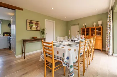 a dining room with a table and chairs at Foxhole Cottage in Stowmarket