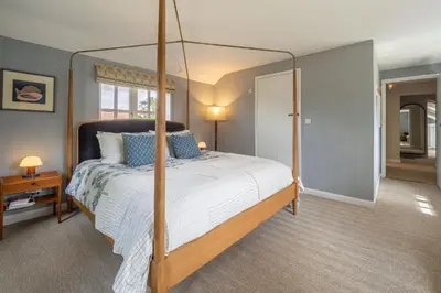 a bedroom with a canopy bed in a room at Foxhole Cottage in Stowmarket