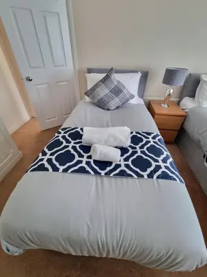 a bedroom with a bed with two towels on it at Contractors Home from Home in South Benfleet