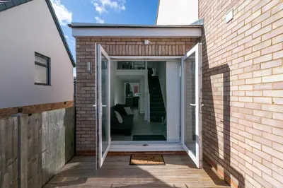 a glass extension to a brick building at King Pin Corner in Stevenage