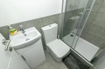 a bathroom with a toilet and a sink and a shower at King Pin Corner in Stevenage