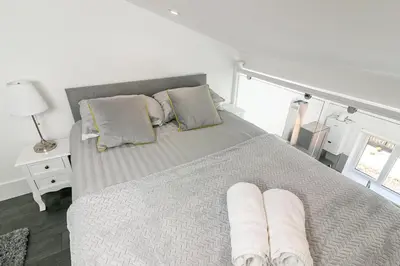 a bedroom with a bed with two pillows on it at King Pin Corner in Stevenage
