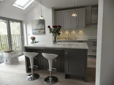 a kitchen with a island with a vase of flowers at Archers House in Stevenage