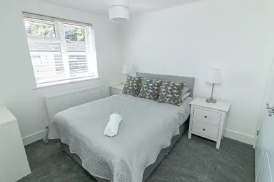 a bedroom with a bed with a white pillow on it at Archers House in Stevenage